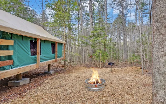 a kitchen with a refrigerator and a wooden floor