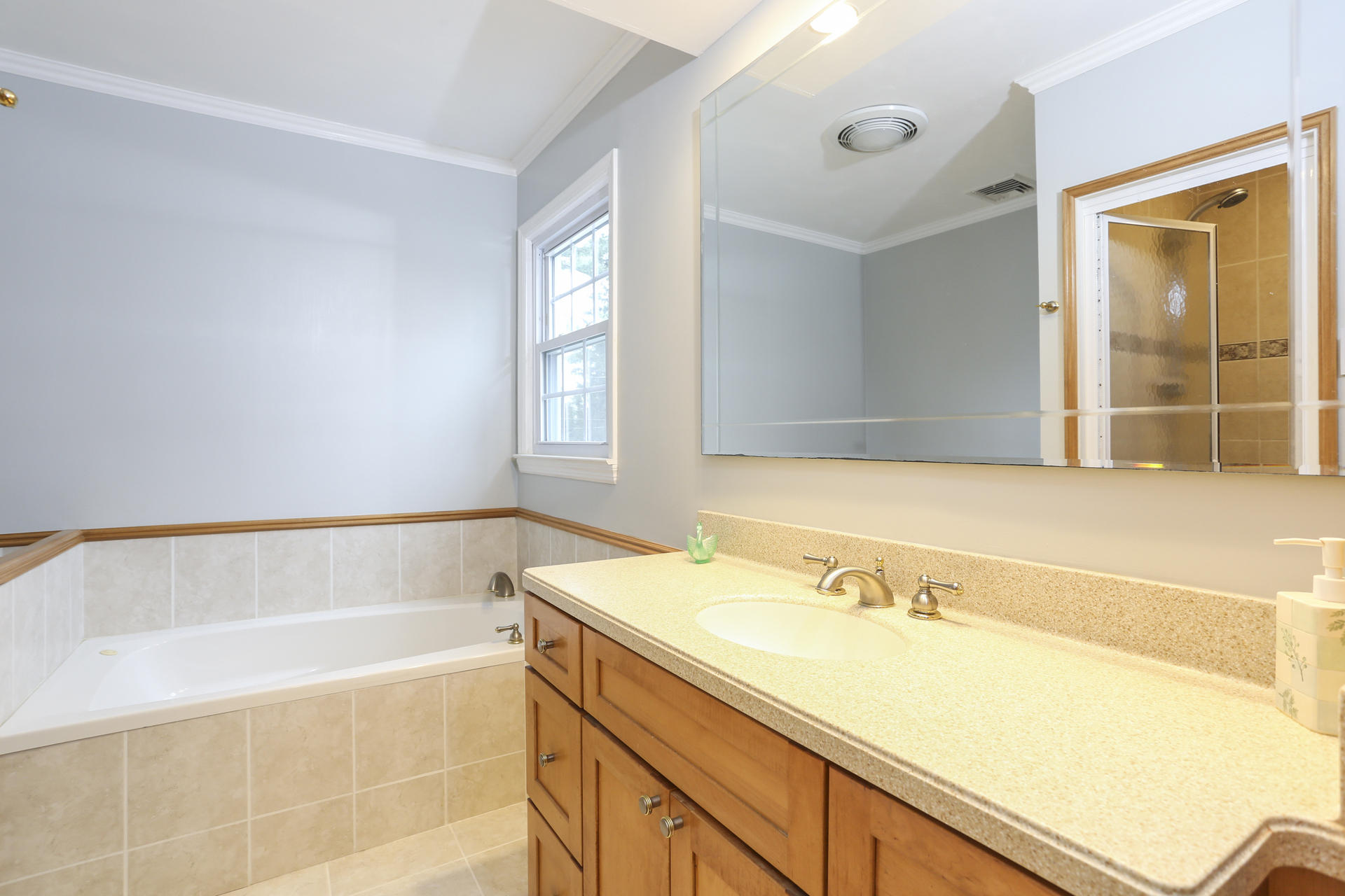 19 Middlesex Road Darien, CT 06820 - Photo 21 of 37 a bathroom with a tub sink and mirror
