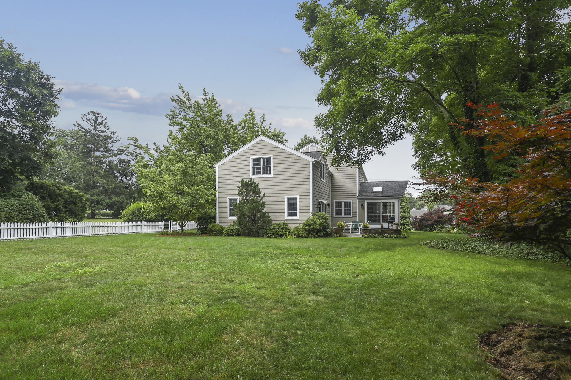 19 Middlesex Road Darien, CT 06820 - Photo 31 of 37 a front view of a house with a yard and trees