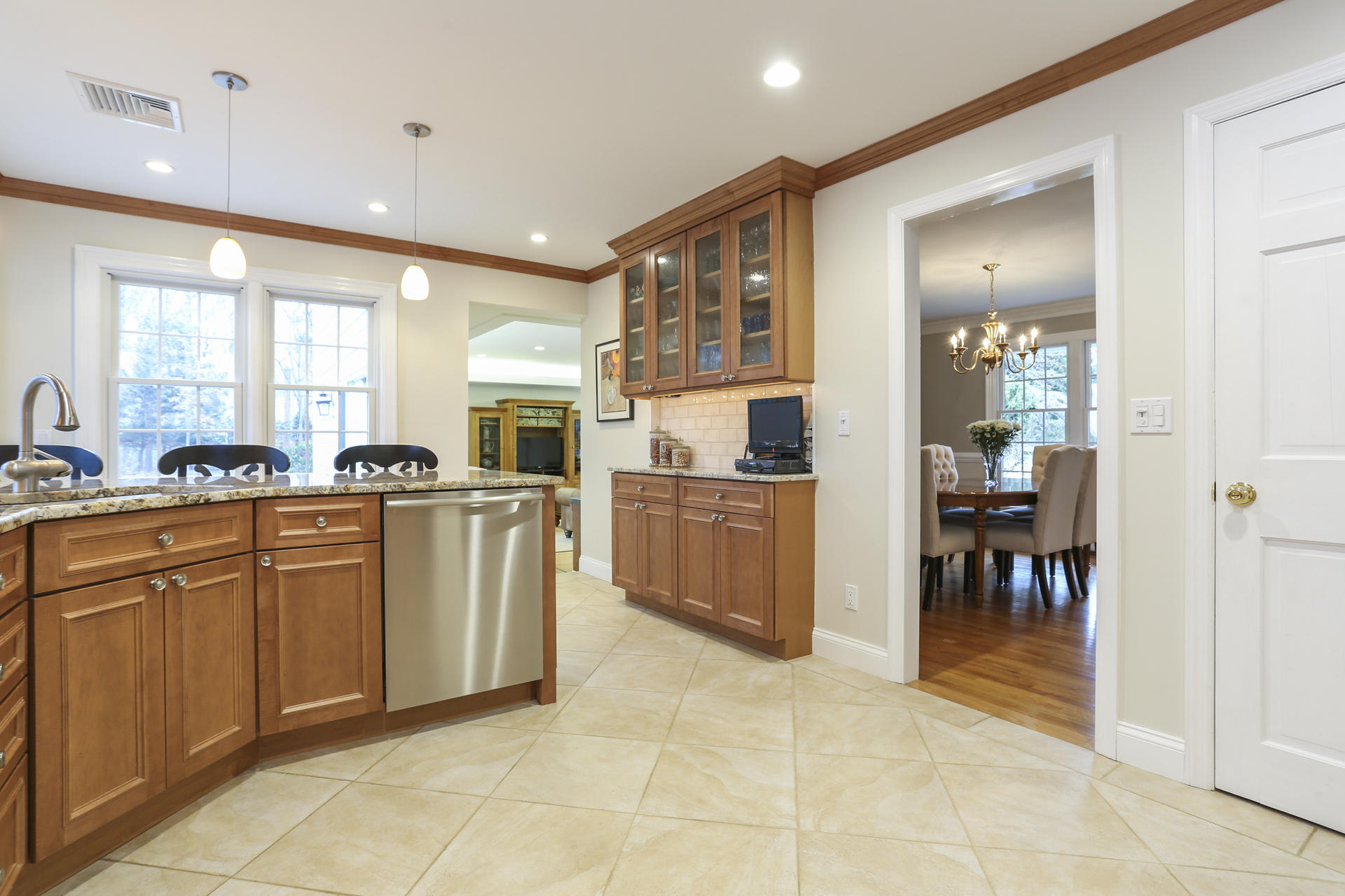 19 Middlesex Road Darien, CT 06820 - Photo 8 of 37 a large kitchen with granite countertop a stove a sink a dining table and chairs