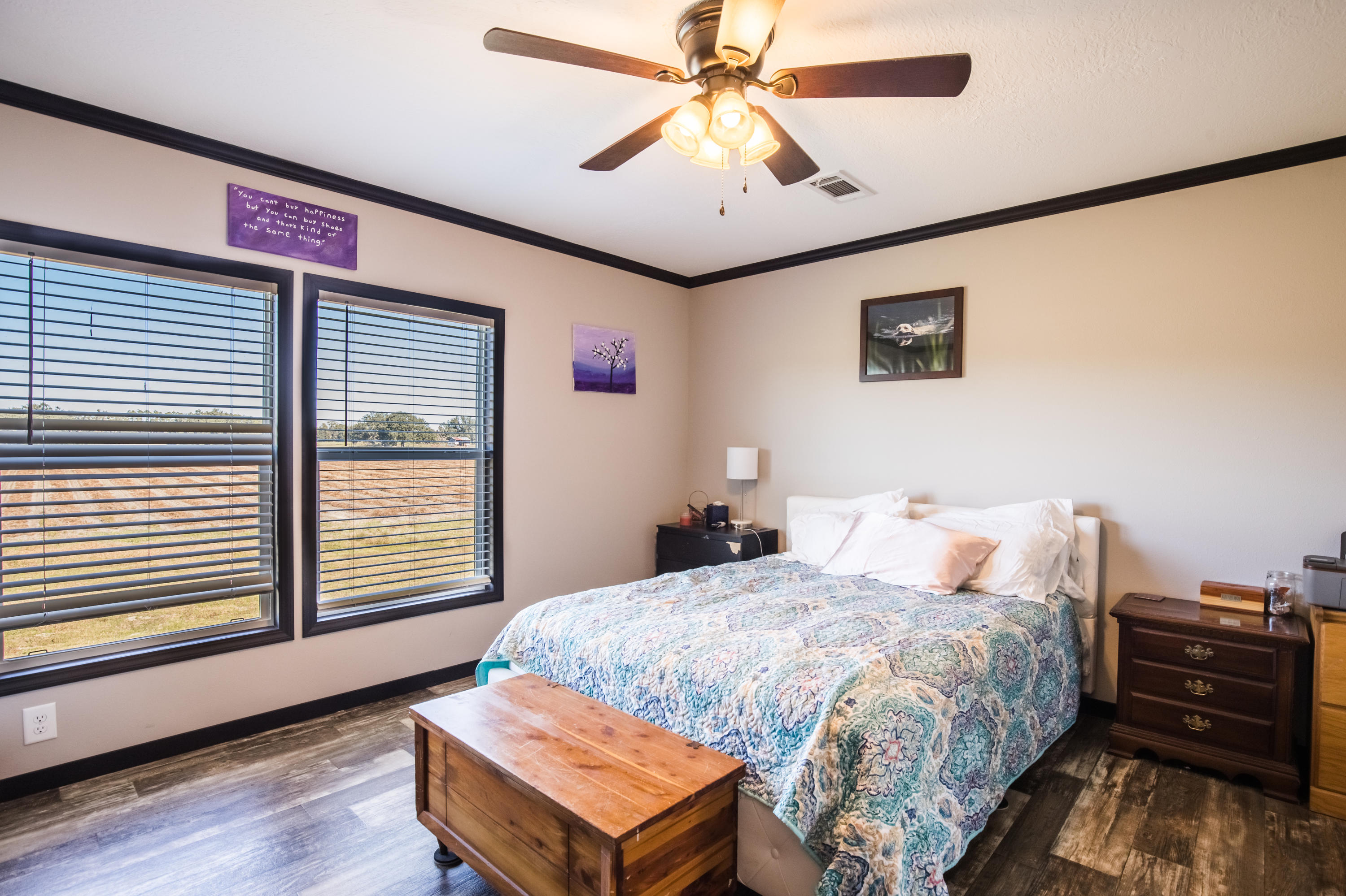 5133 Creek Road Vernon, FL 32462 - Photo 20 of 36 a bedroom with a bed and a chandelier