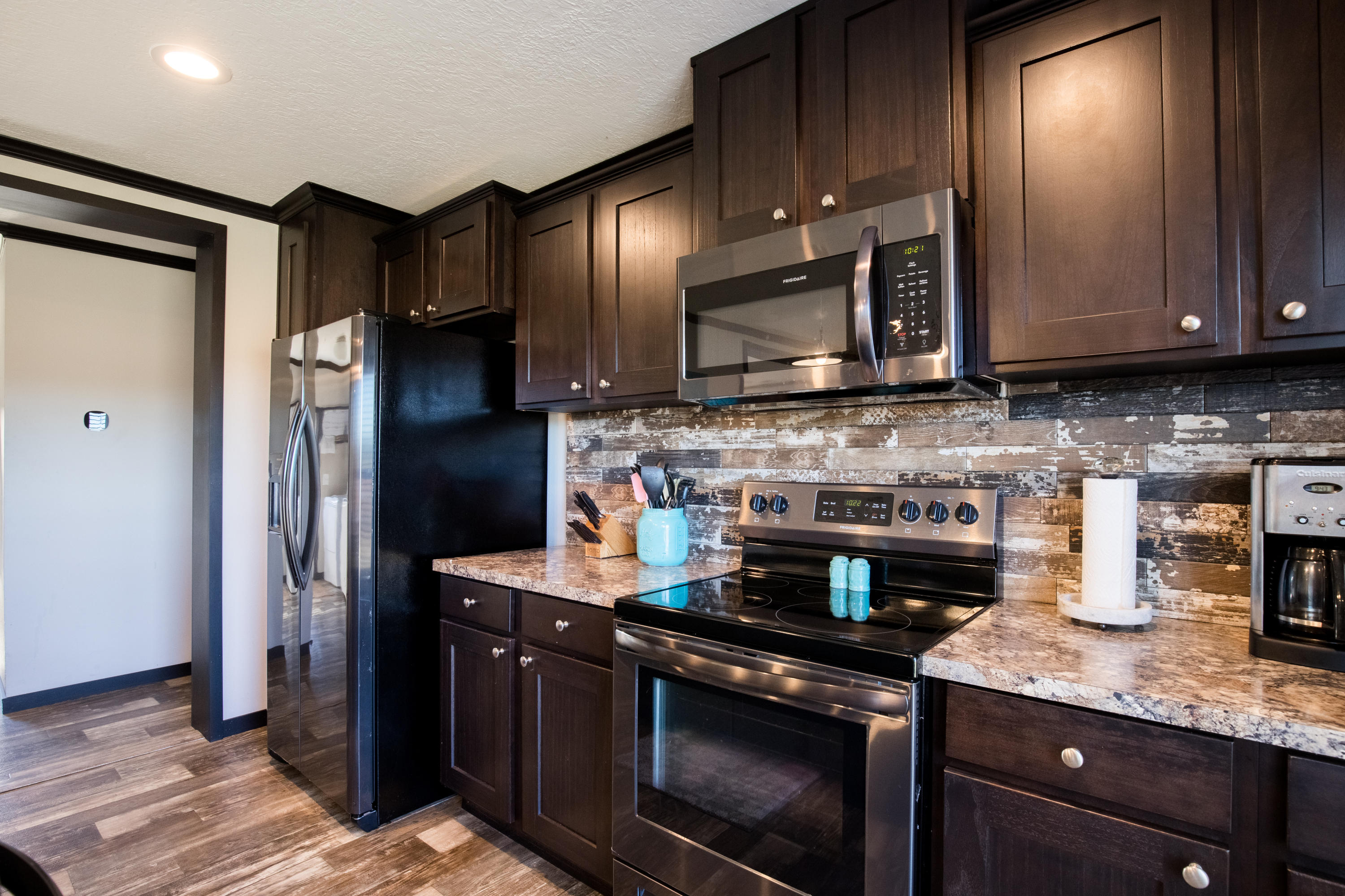 5133 Creek Road Vernon, FL 32462 - Photo 8 of 36 a kitchen with granite countertop stainless steel appliances and wooden cabinets