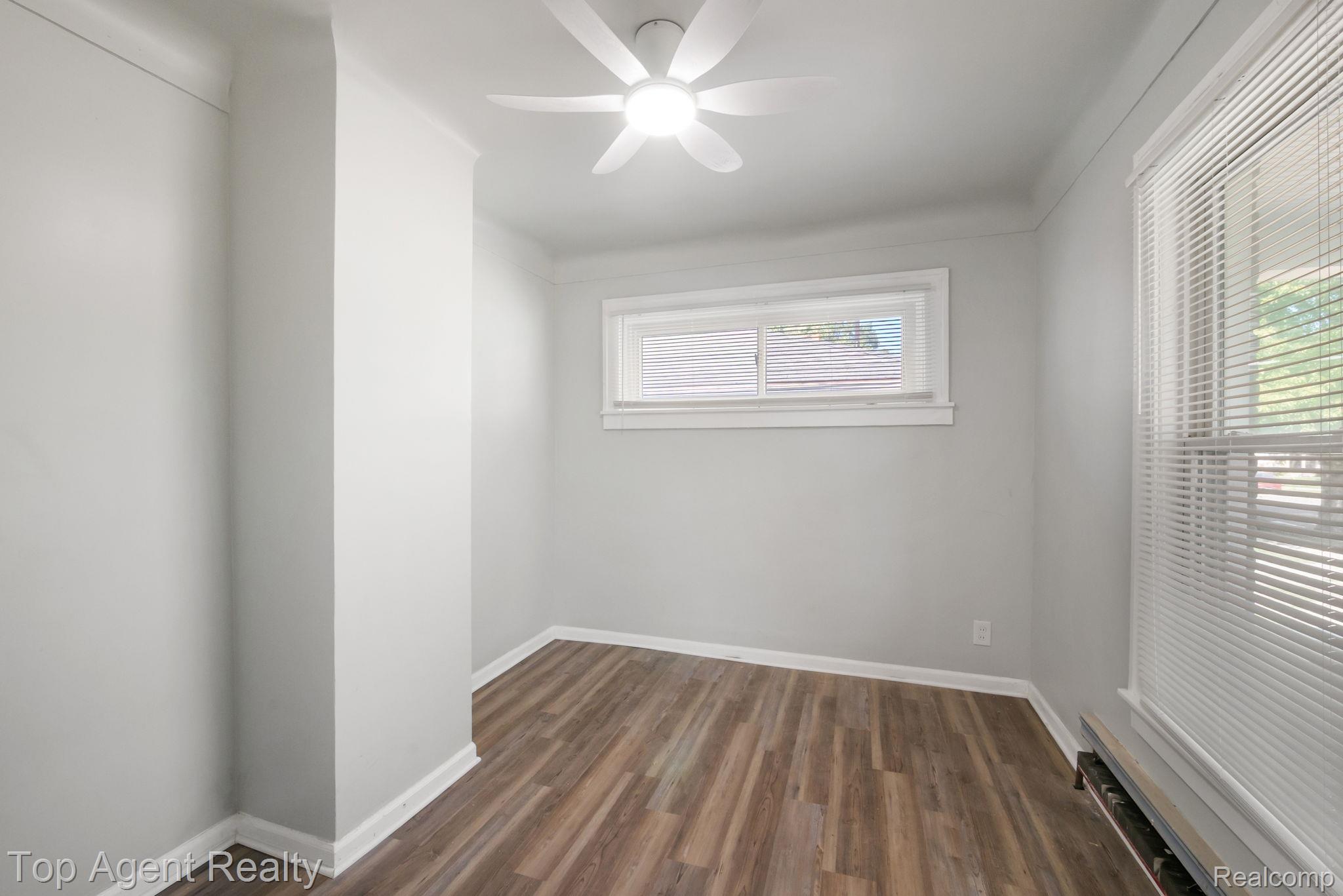 19217 Reno Street Detroit, MI 48205 - Photo 15 of 45 Wood-finish flooring, white trim, and a ceiling fan with integrated lighting