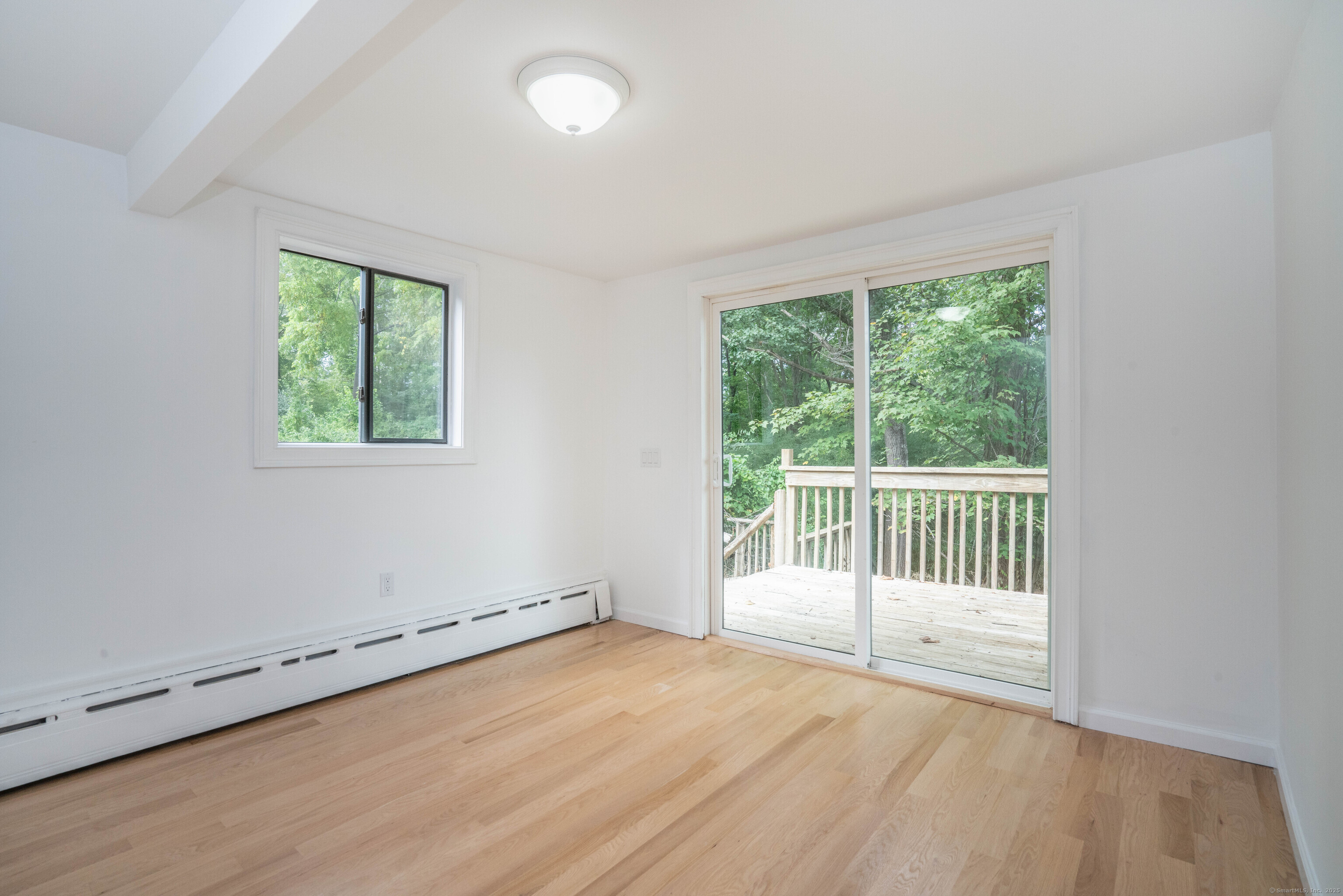 14 Main St Extension Simsbury, CT 06081 - Photo 14 of 39 an empty room with wooden floor and windows