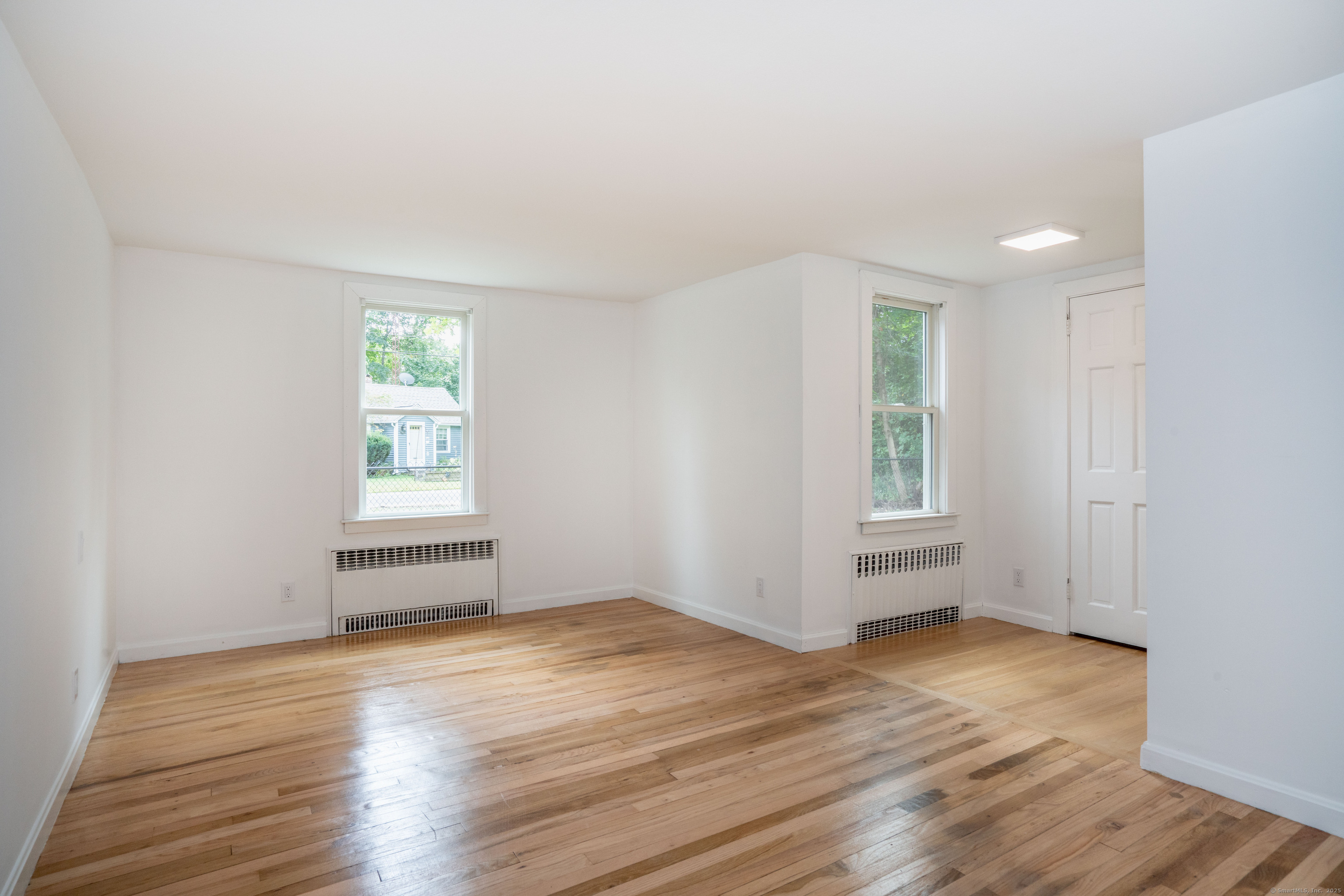 14 Main St Extension Simsbury, CT 06081 - Photo 18 of 39 an empty room with wooden floor and windows