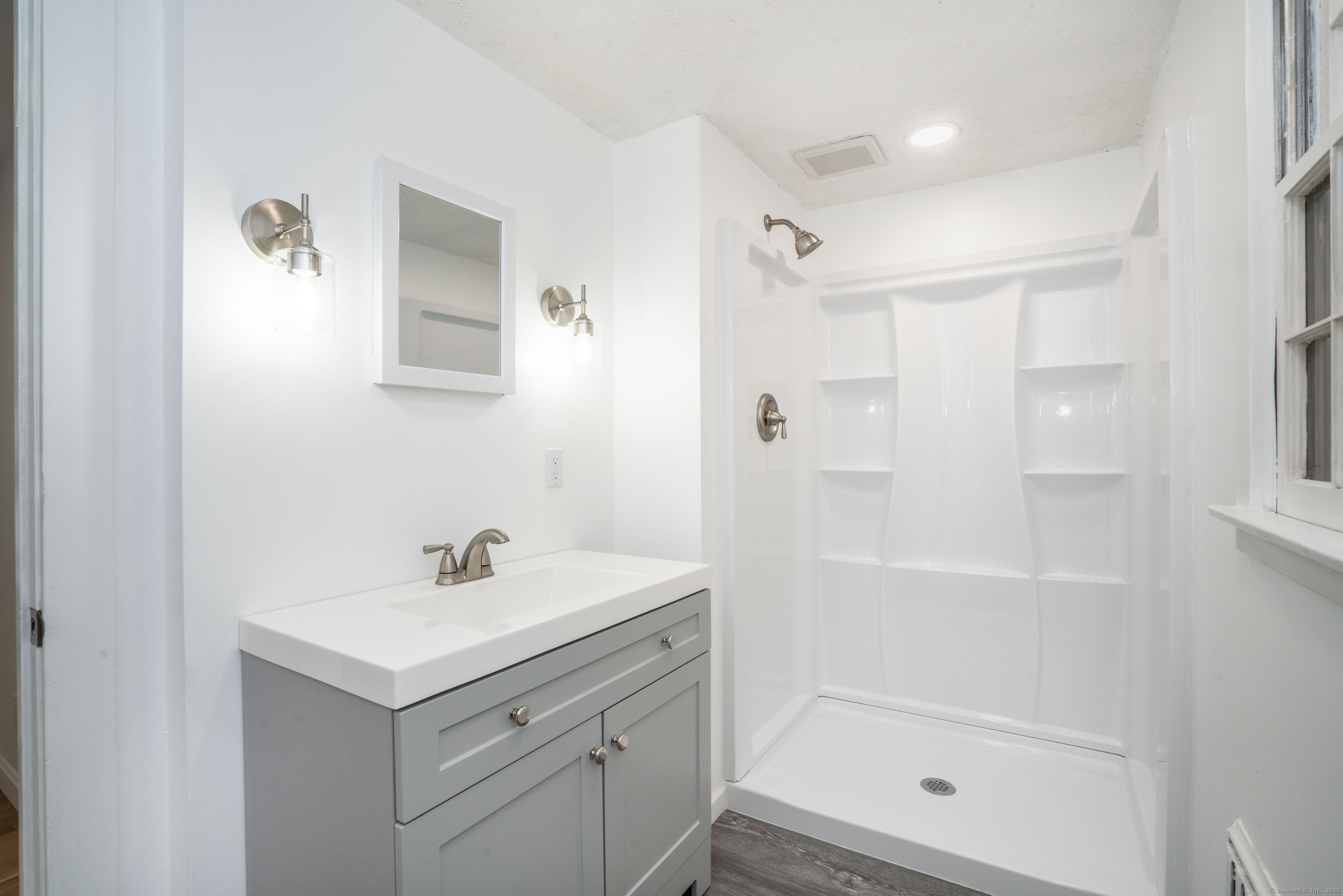 14 Main St Extension Simsbury, CT 06081 - Photo 21 of 39 a bathroom with a shower sink and mirror