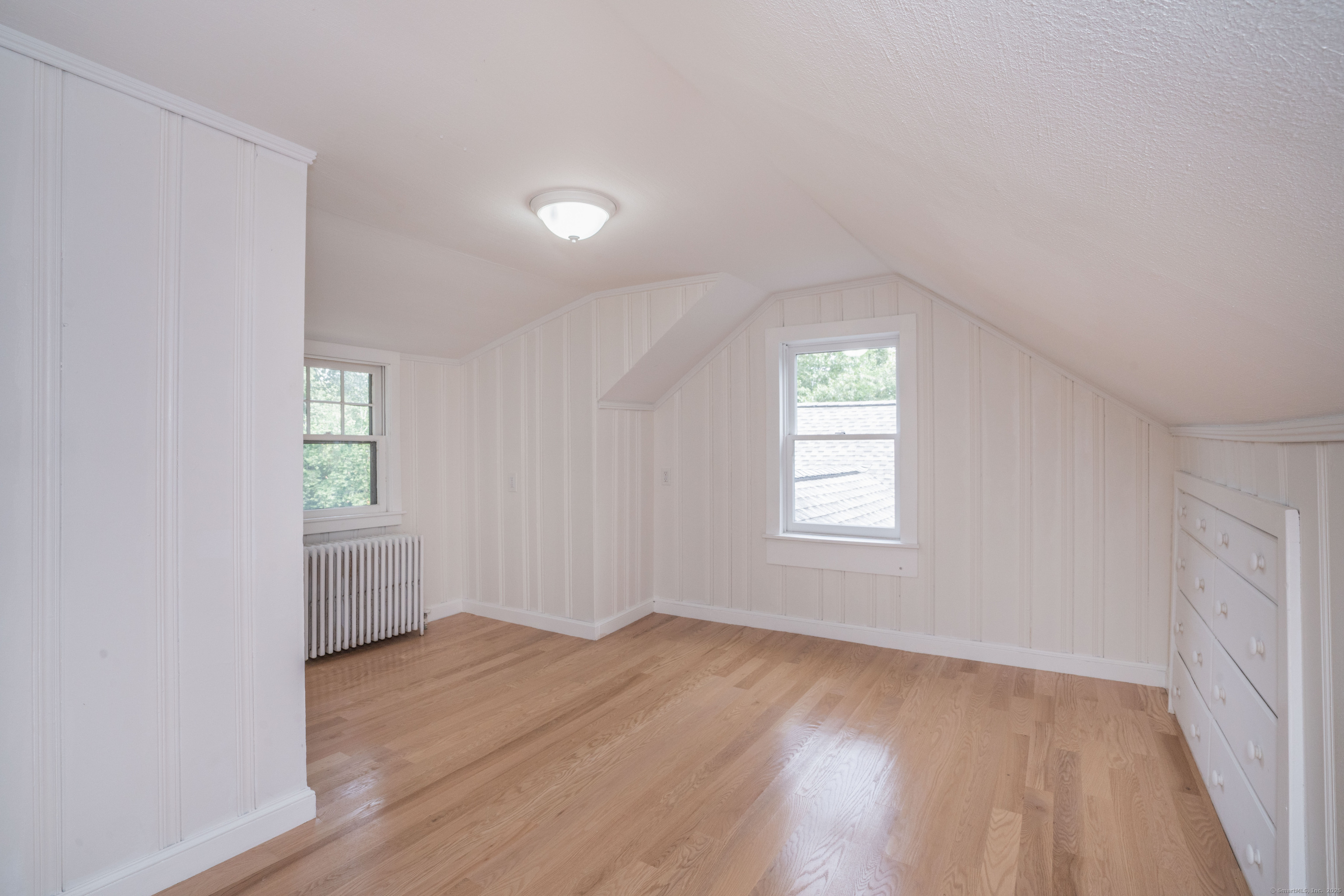 14 Main St Extension Simsbury, CT 06081 - Photo 23 of 39 an empty room with wooden floor and windows