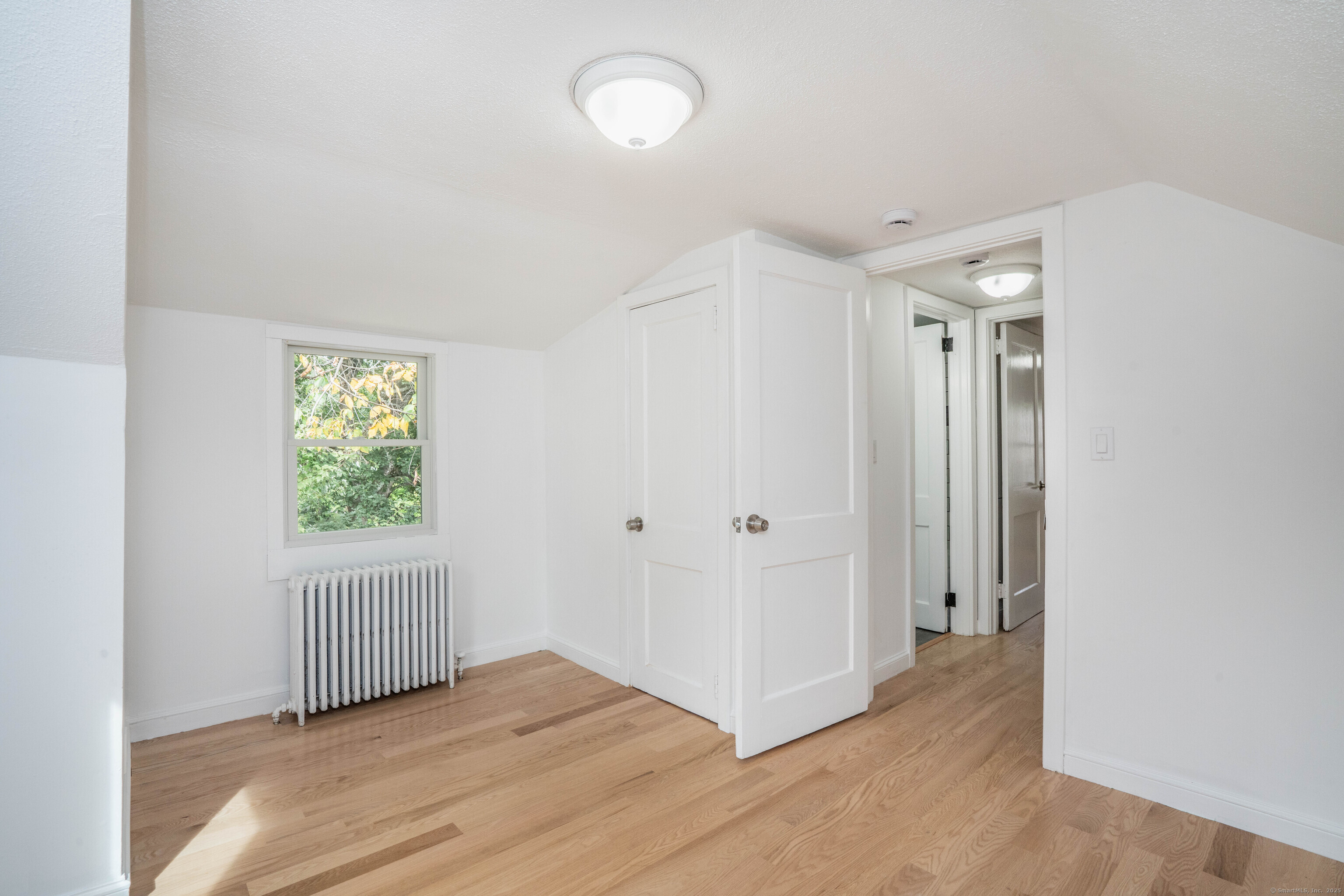 14 Main St Extension Simsbury, CT 06081 - Photo 29 of 39 an empty room with wooden floor and windows