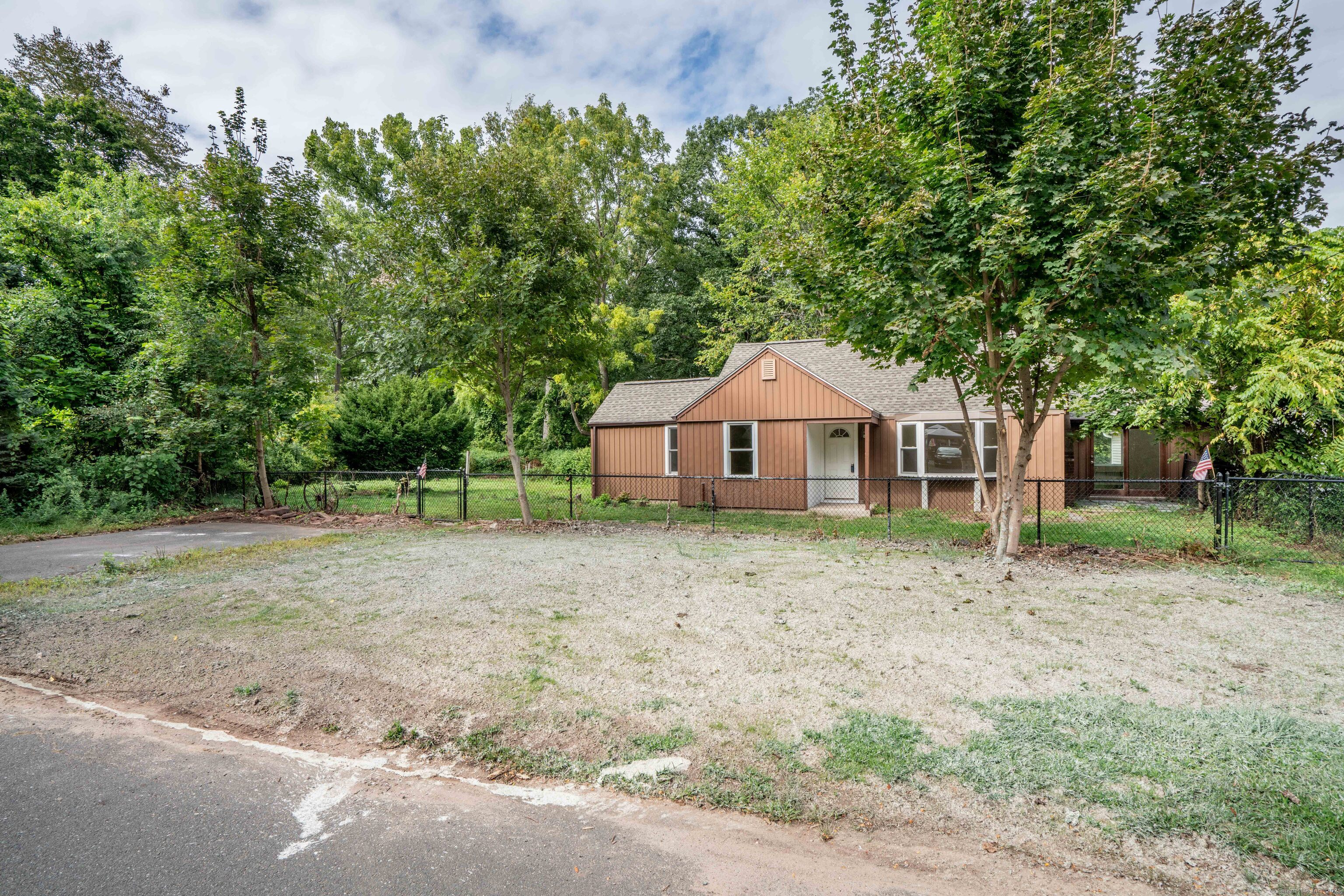 14 Main St Extension Simsbury, CT 06081 - Photo 38 of 39 a front view of a house with a yard and garage