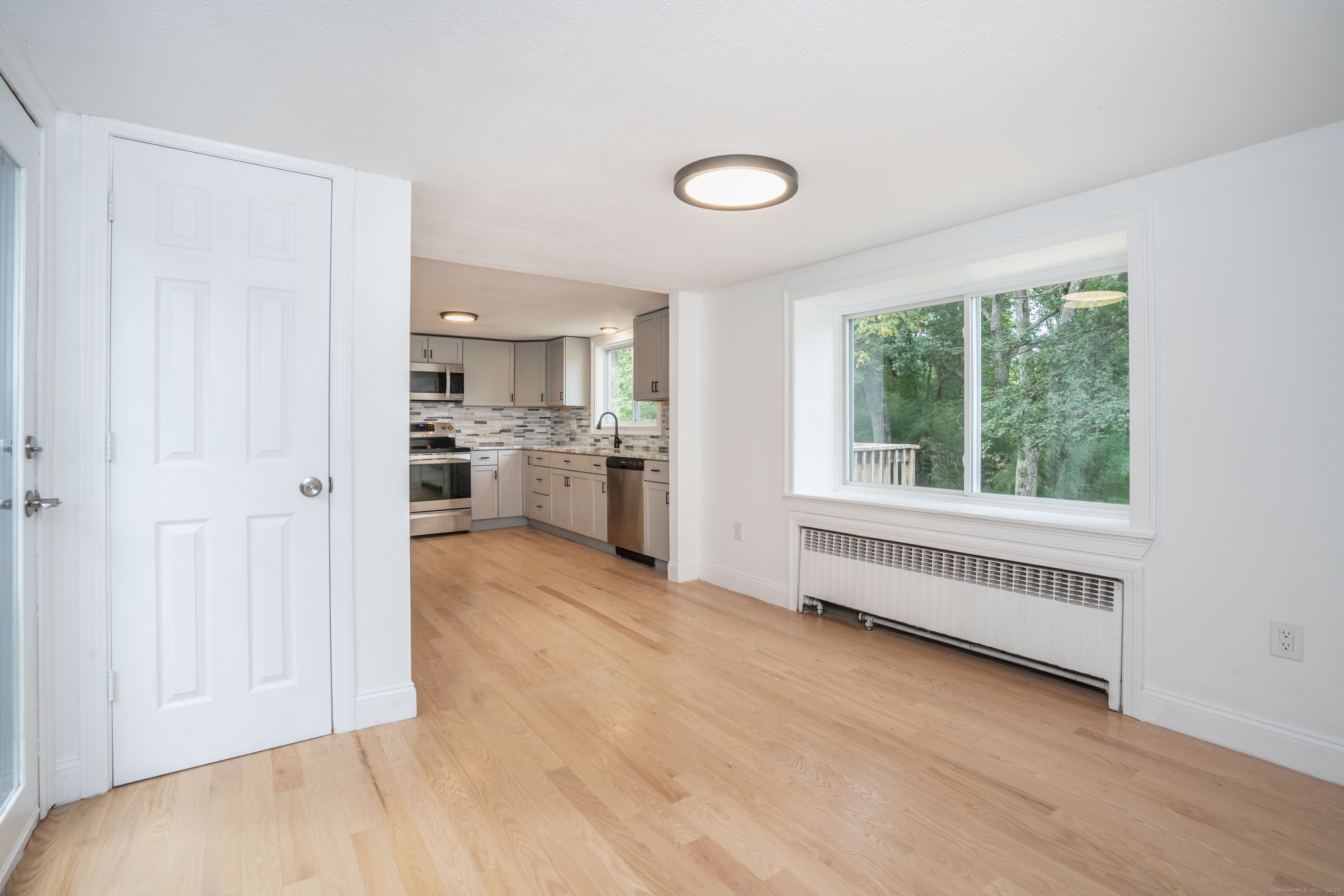 14 Main St Extension Simsbury, CT 06081 - Photo 6 of 39 a view of a kitchen with a sink dishwasher and a refrigerator