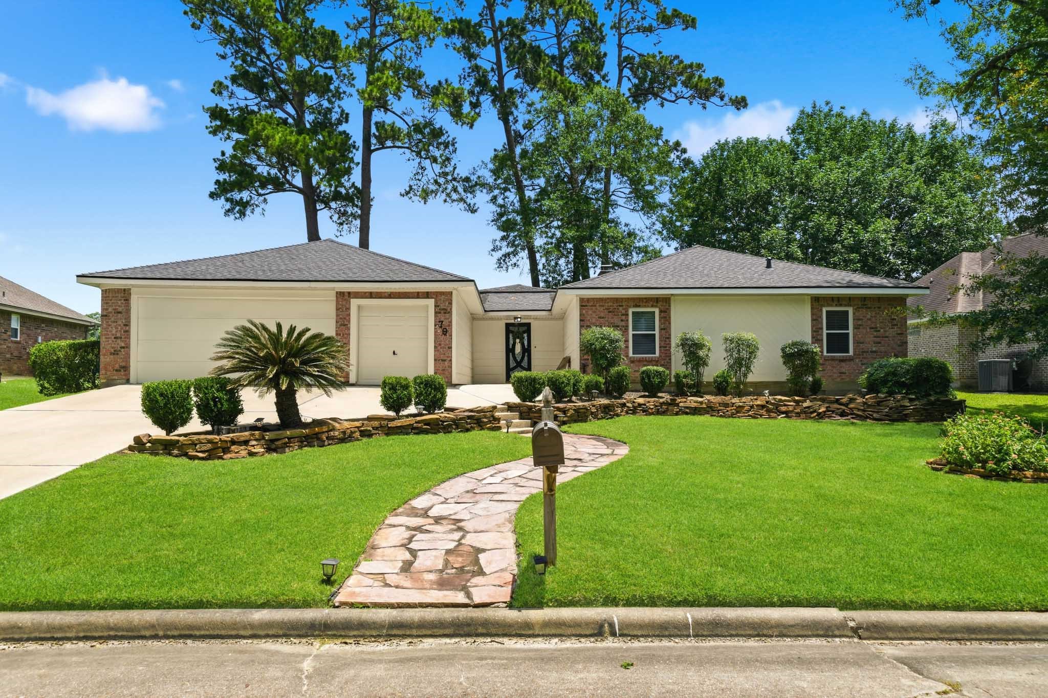 79 Summers Wind Street Conroe, TX 77356 - Photo 45 of 45 a front view of a house with a yard
