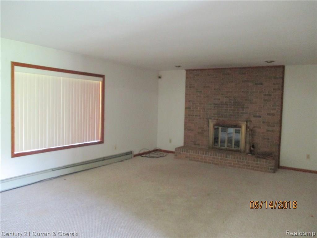 18480 Merriman Road Romulus, MI 48174 - Photo 23 of 30 LARGE LIVING ROOM/BAY WINDOW AND NATURAL FIREPLACE