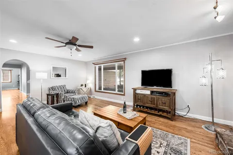 a bedroom with furniture and a flat screen tv