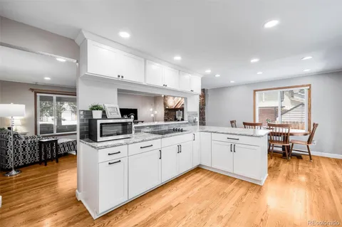 a kitchen with stainless steel appliances granite countertop refrigerator sink and stove