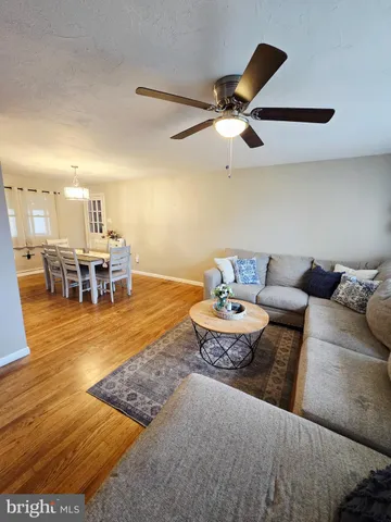 a living room with furniture kitchen view and a dining table