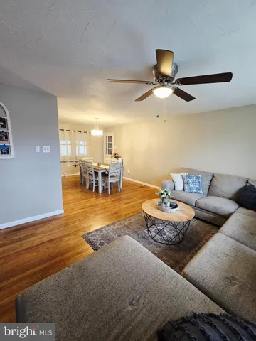 a living room with patio furniture and a chandelier