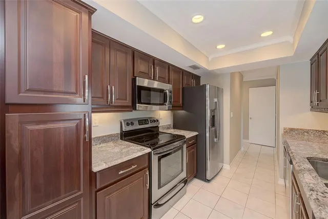 a bathroom with a granite countertop sink a toilet and a mirror