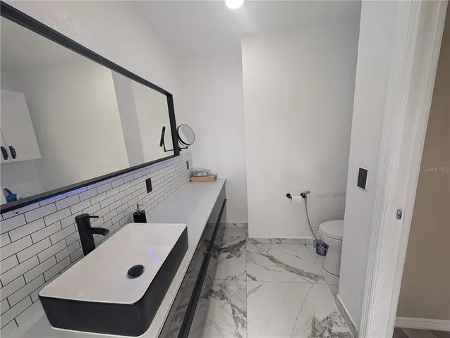 a bathroom with a tub and toilet