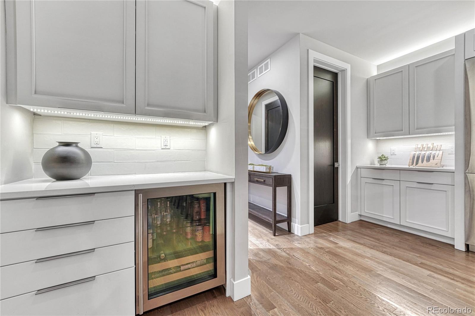 5151 Raintree Circle Parker, CO 80134 - Photo 11 of 50 a kitchen with a refrigerator and cabinets