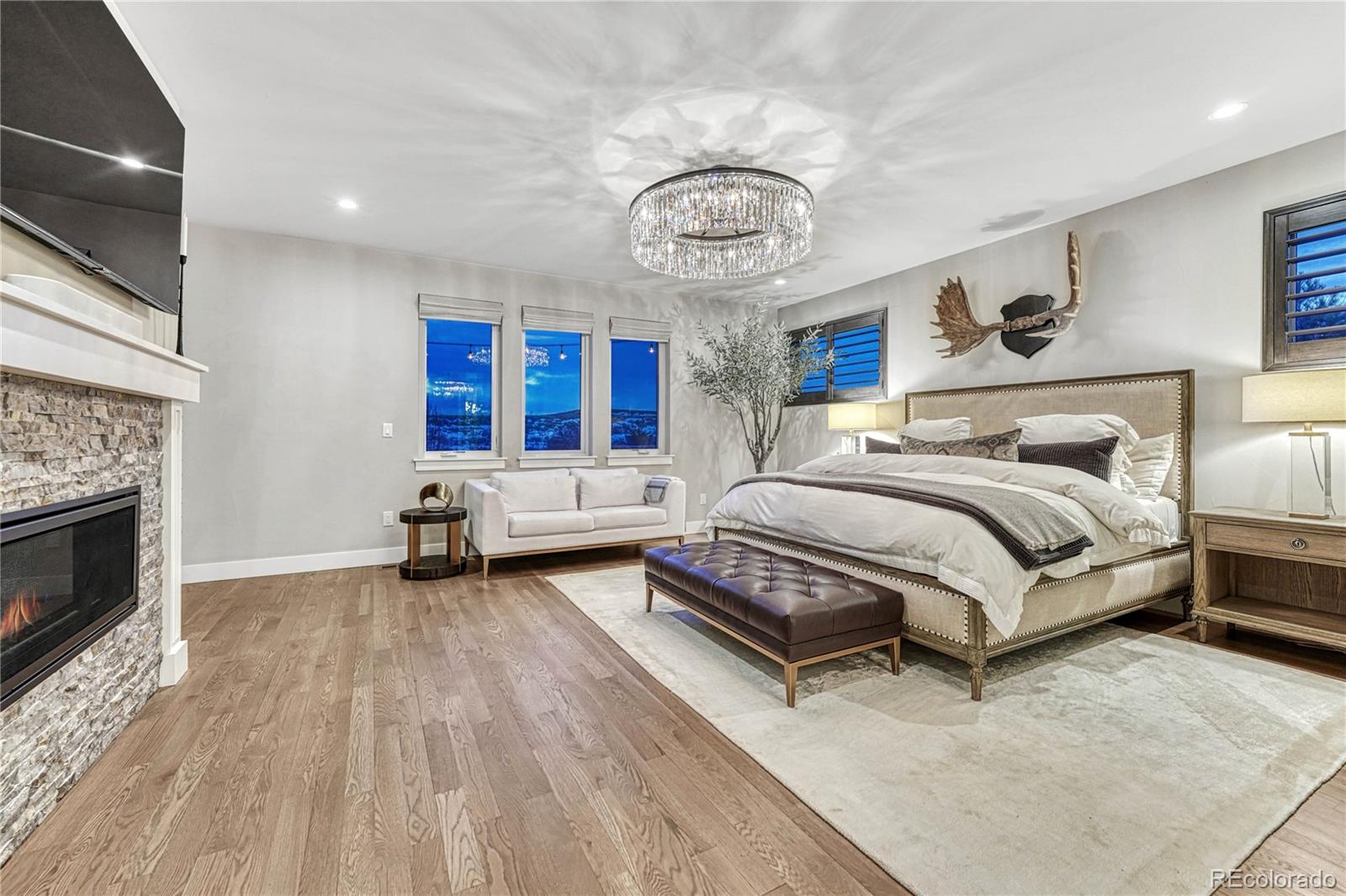 5151 Raintree Circle Parker, CO 80134 - Photo 14 of 50 a bedroom with a bed and a fireplace