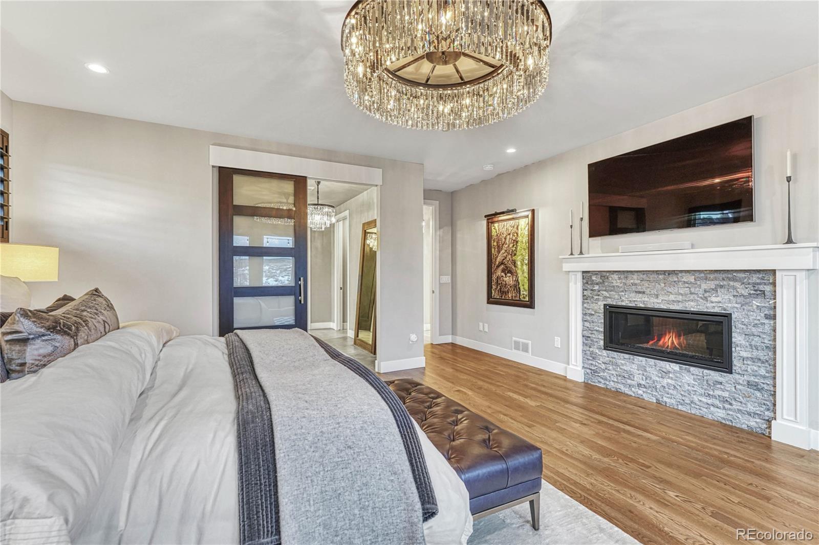 5151 Raintree Circle Parker, CO 80134 - Photo 15 of 50 a spacious bedroom with a bed and a television