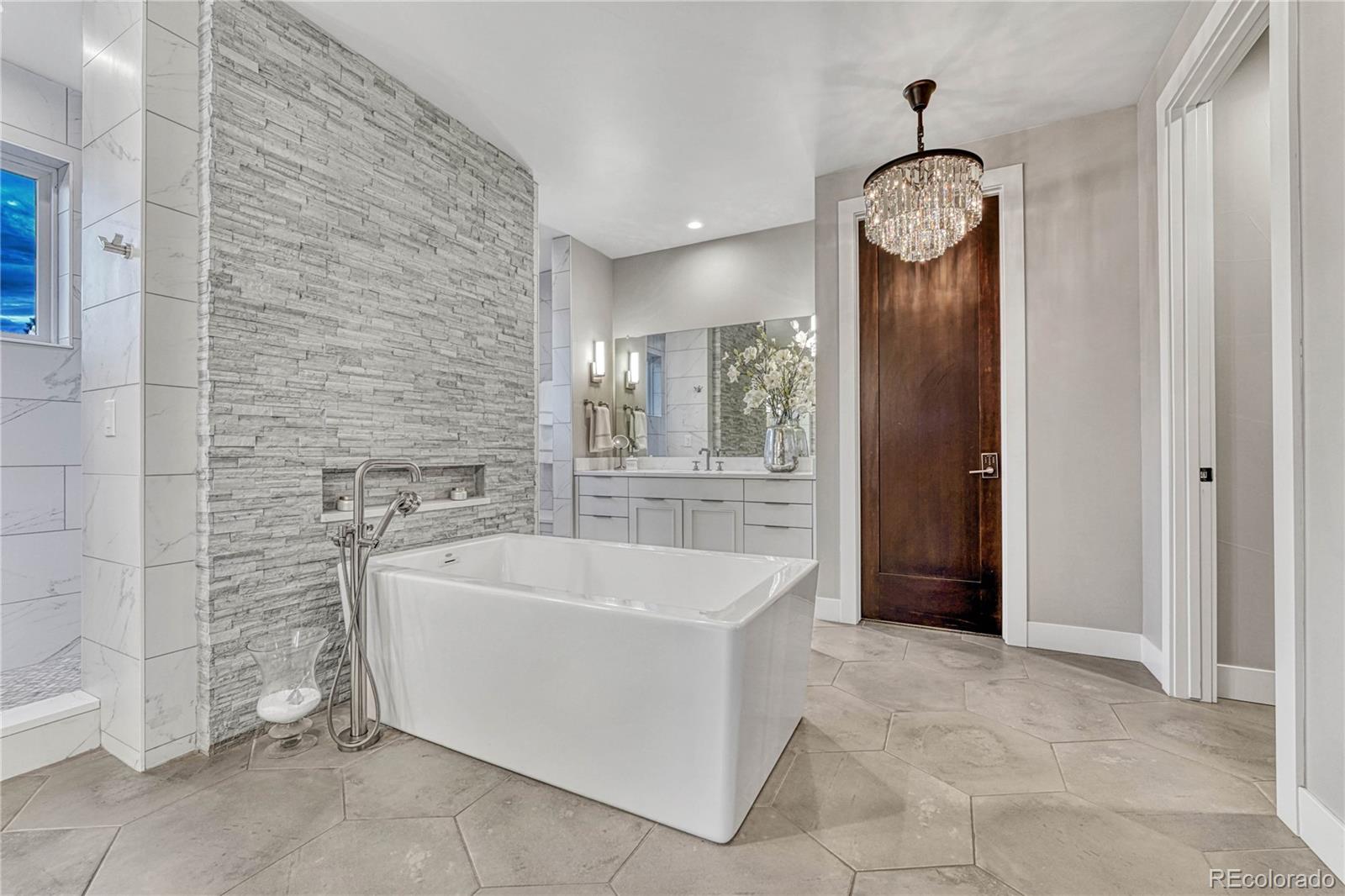 5151 Raintree Circle Parker, CO 80134 - Photo 16 of 50 a spacious bathroom with a sink and mirror