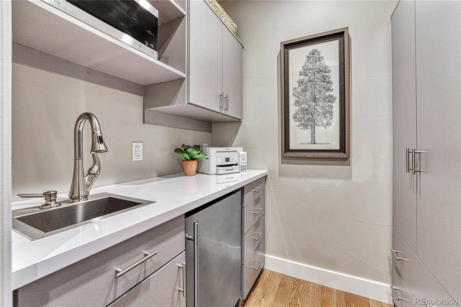 5151 Raintree Circle Parker, CO 80134 - Photo 19 of 50 a kitchen with stainless steel appliances a sink and cabinets