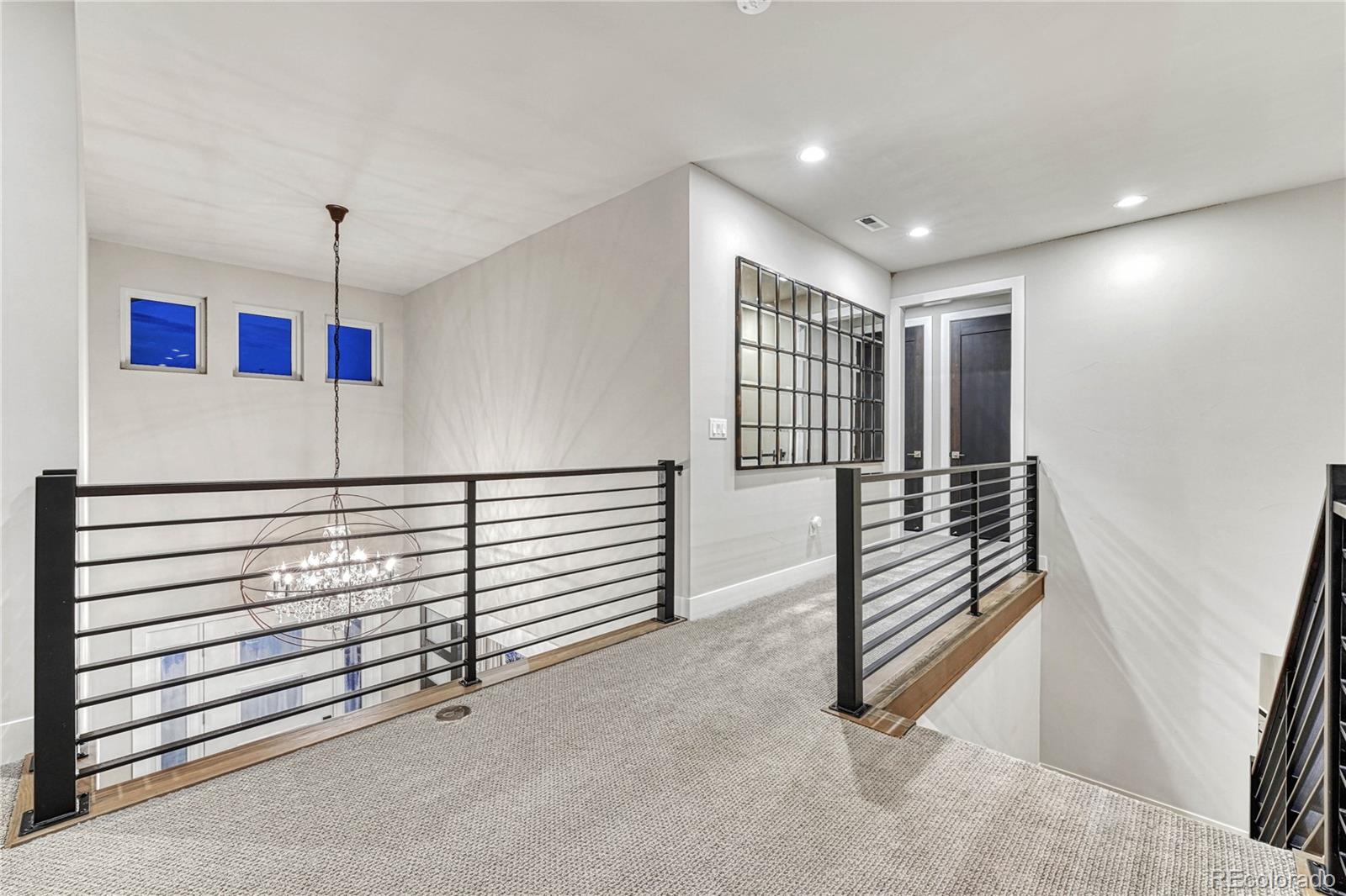 5151 Raintree Circle Parker, CO 80134 - Photo 21 of 50 a view of a hallway with stairs and a ceiling fan