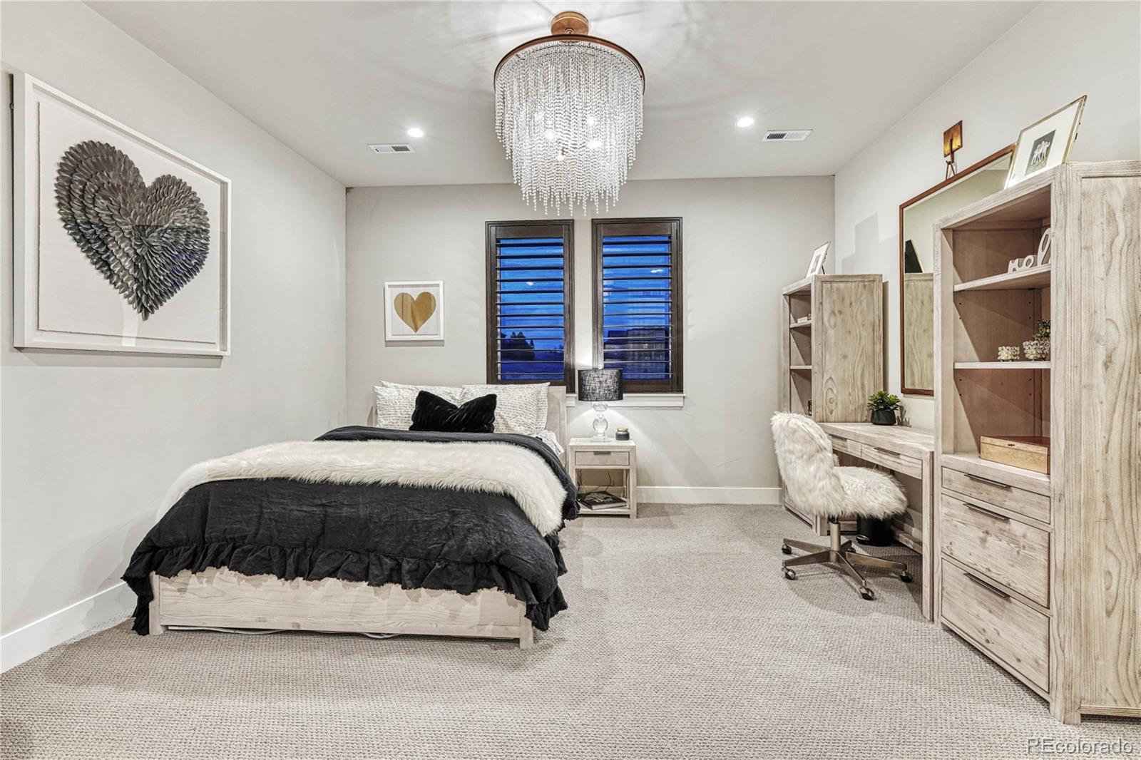 5151 Raintree Circle Parker, CO 80134 - Photo 24 of 50 a bedroom with a bed and a chandelier