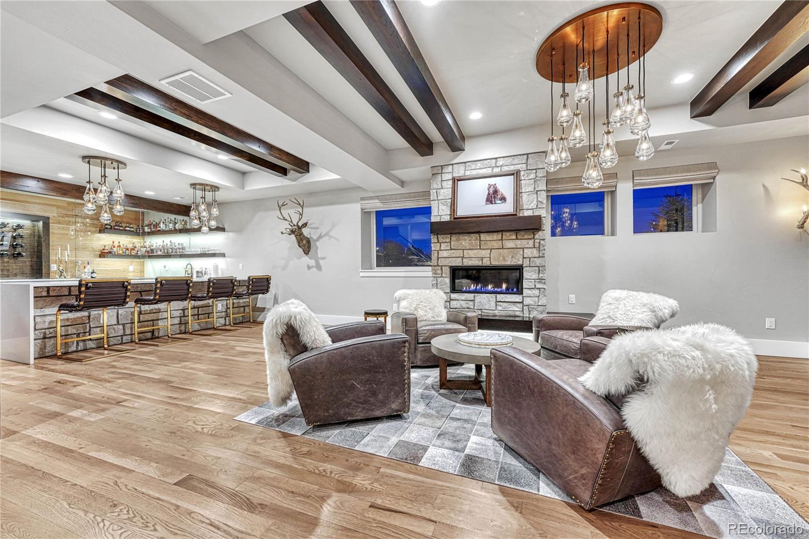 5151 Raintree Circle Parker, CO 80134 - Photo 27 of 50 a living room with fireplace furniture and a chandelier