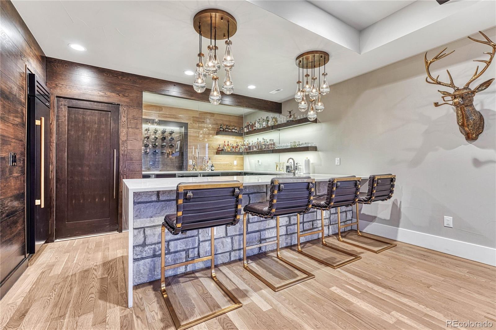 5151 Raintree Circle Parker, CO 80134 - Photo 31 of 50 a room with lots of wooden furniture and chandelier