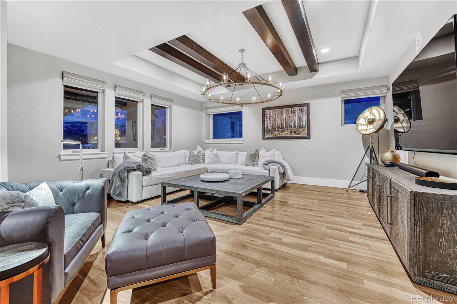 5151 Raintree Circle Parker, CO 80134 - Photo 34 of 50 a living room with furniture a flat screen tv and a table