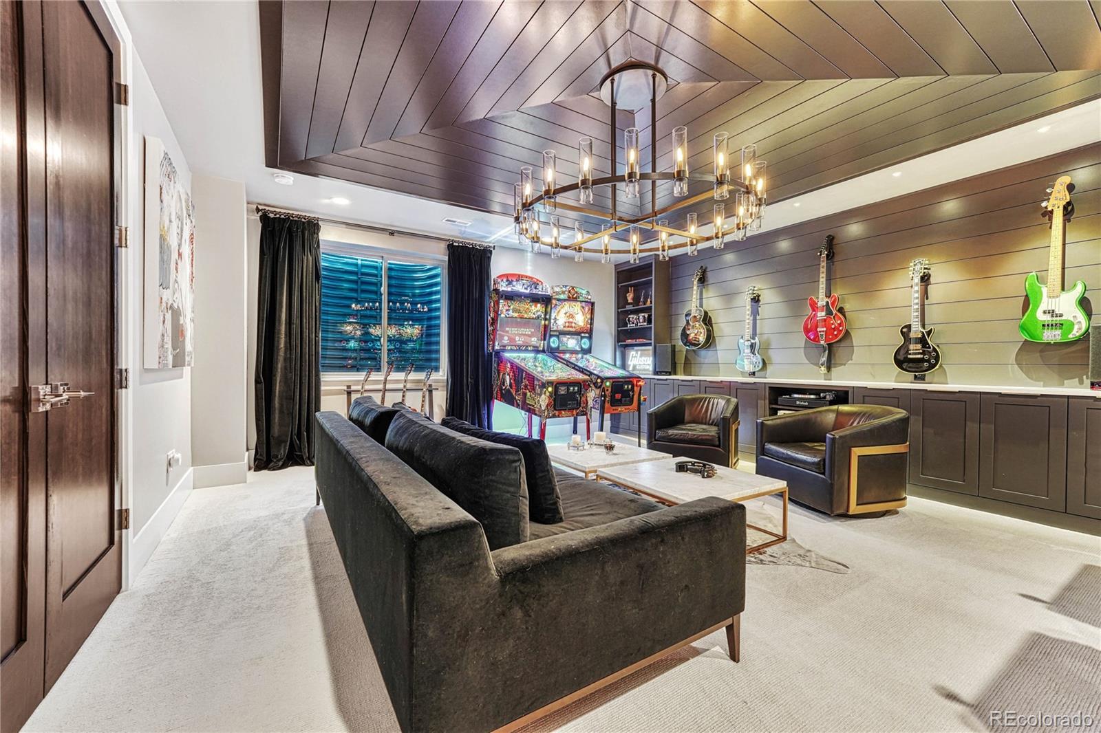 5151 Raintree Circle Parker, CO 80134 - Photo 36 of 50 a living room with furniture a chandelier and kitchen view