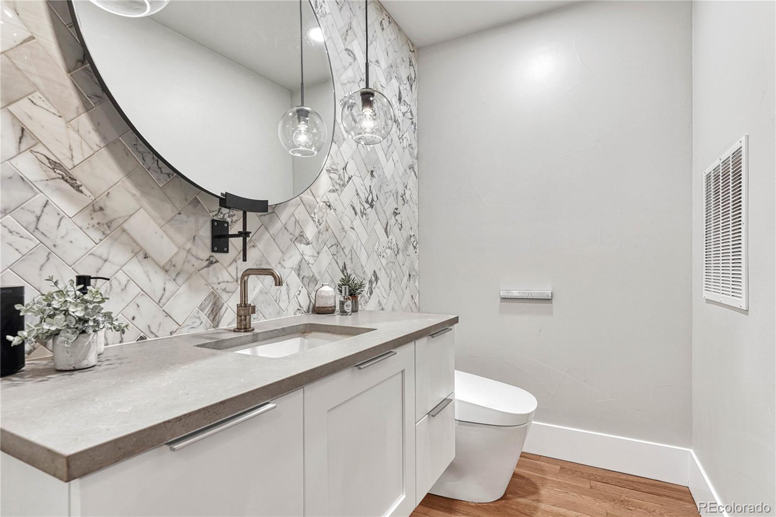 5151 Raintree Circle Parker, CO 80134 - Photo 39 of 50 a bathroom with a sink a toilet and mirror