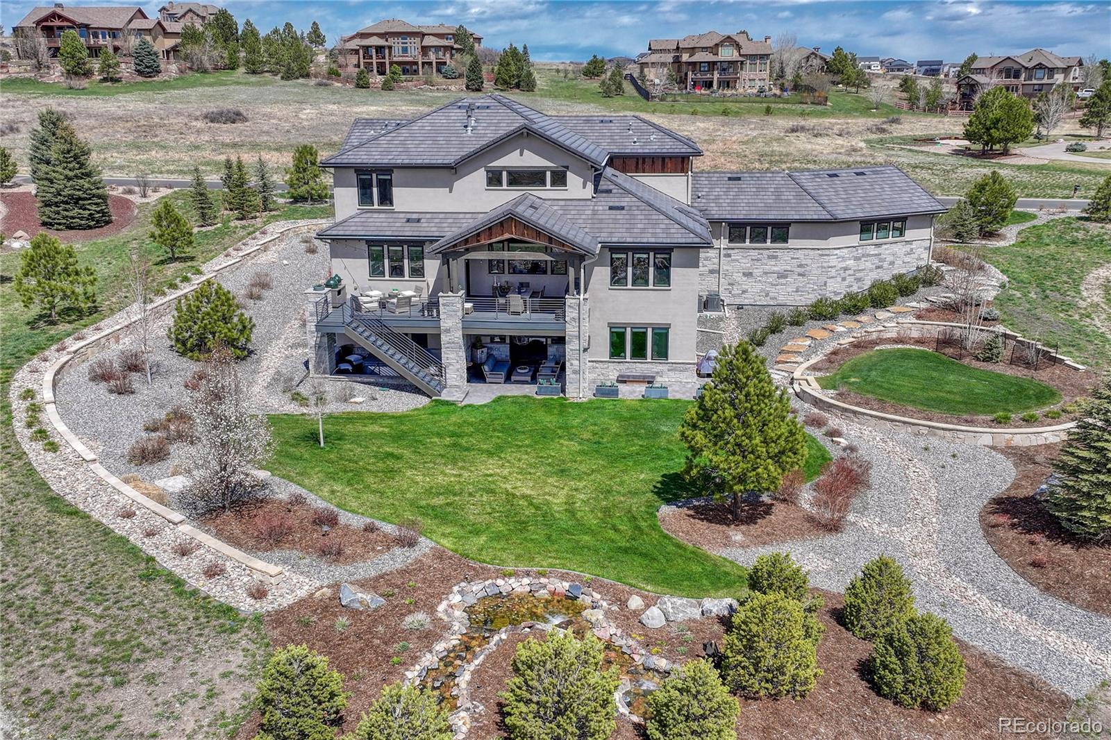 5151 Raintree Circle Parker, CO 80134 - Photo 46 of 50 an aerial view of a house with a garden and lake view