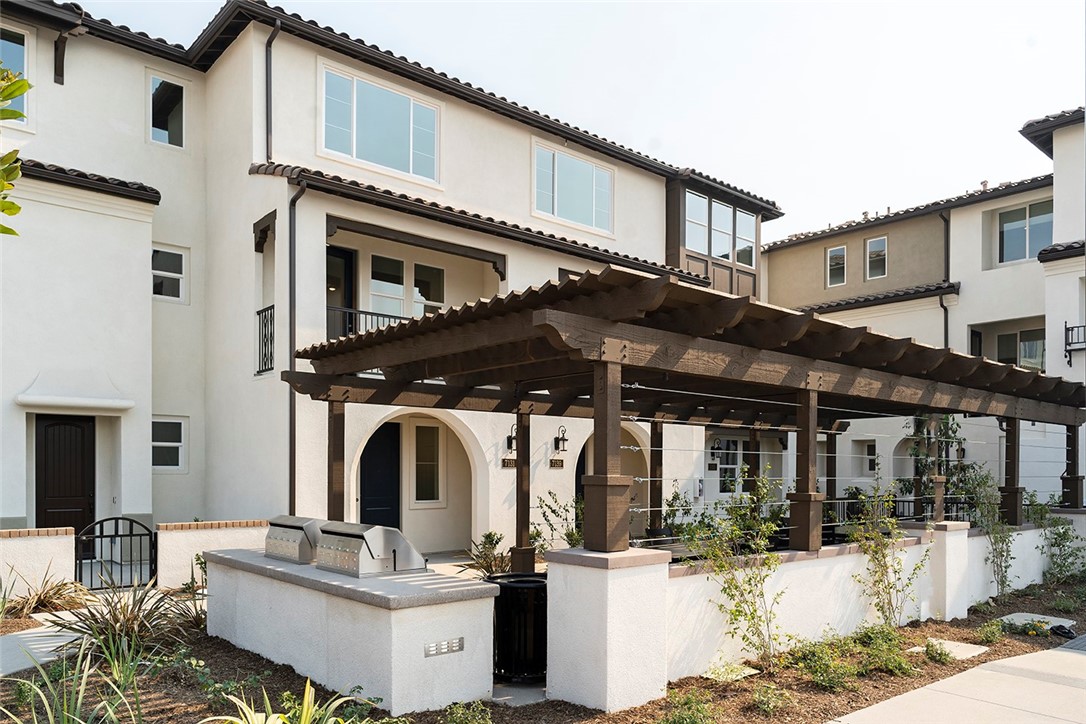 a front view of a house with barbeque grill