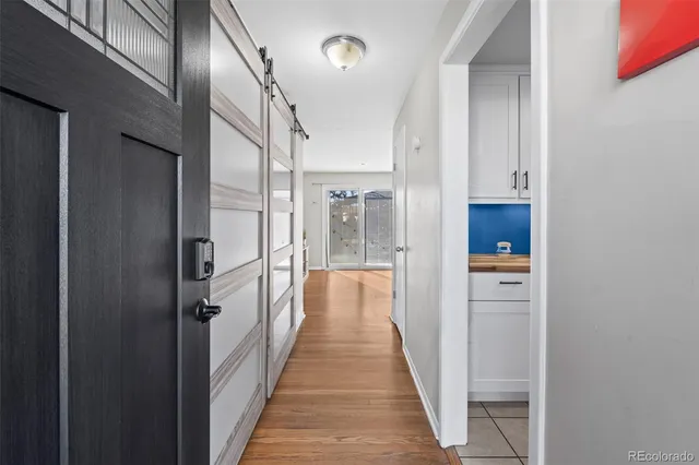 a view of a hallway with wooden floor and staircase