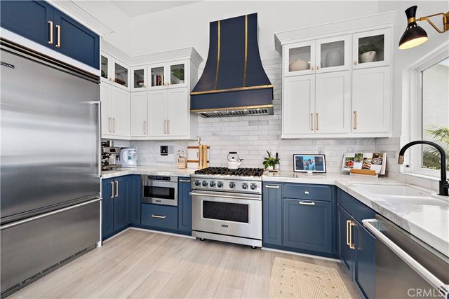 a kitchen with stainless steel appliances granite countertop a stove and a sink