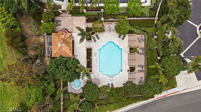 an aerial view of a house with a swimming pool