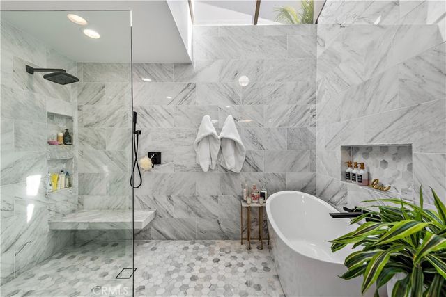 a living room with a couch and a potted plant