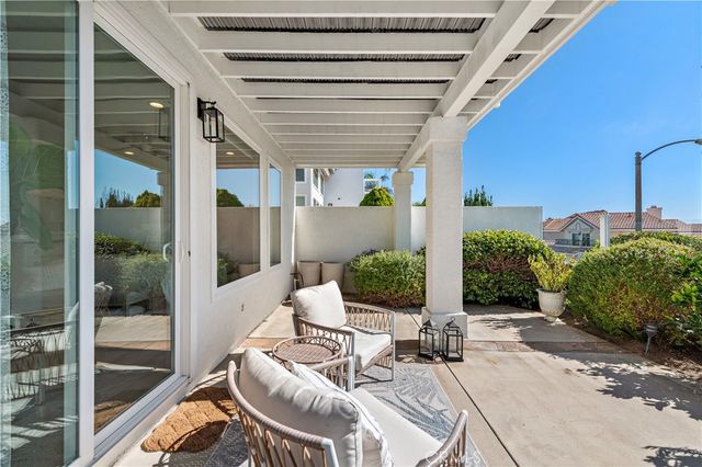 a view of a patio with table and chairs potted plants with wooden floor