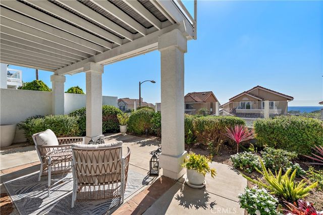 a view of a patio with table and chairs and potted plants