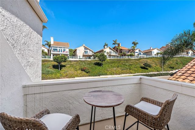 a view of a chairs and table in a balcony