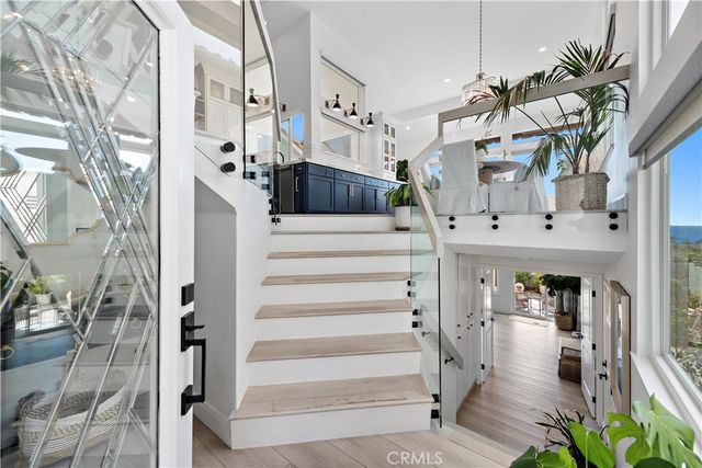 a view of entryway and hall with wooden floor