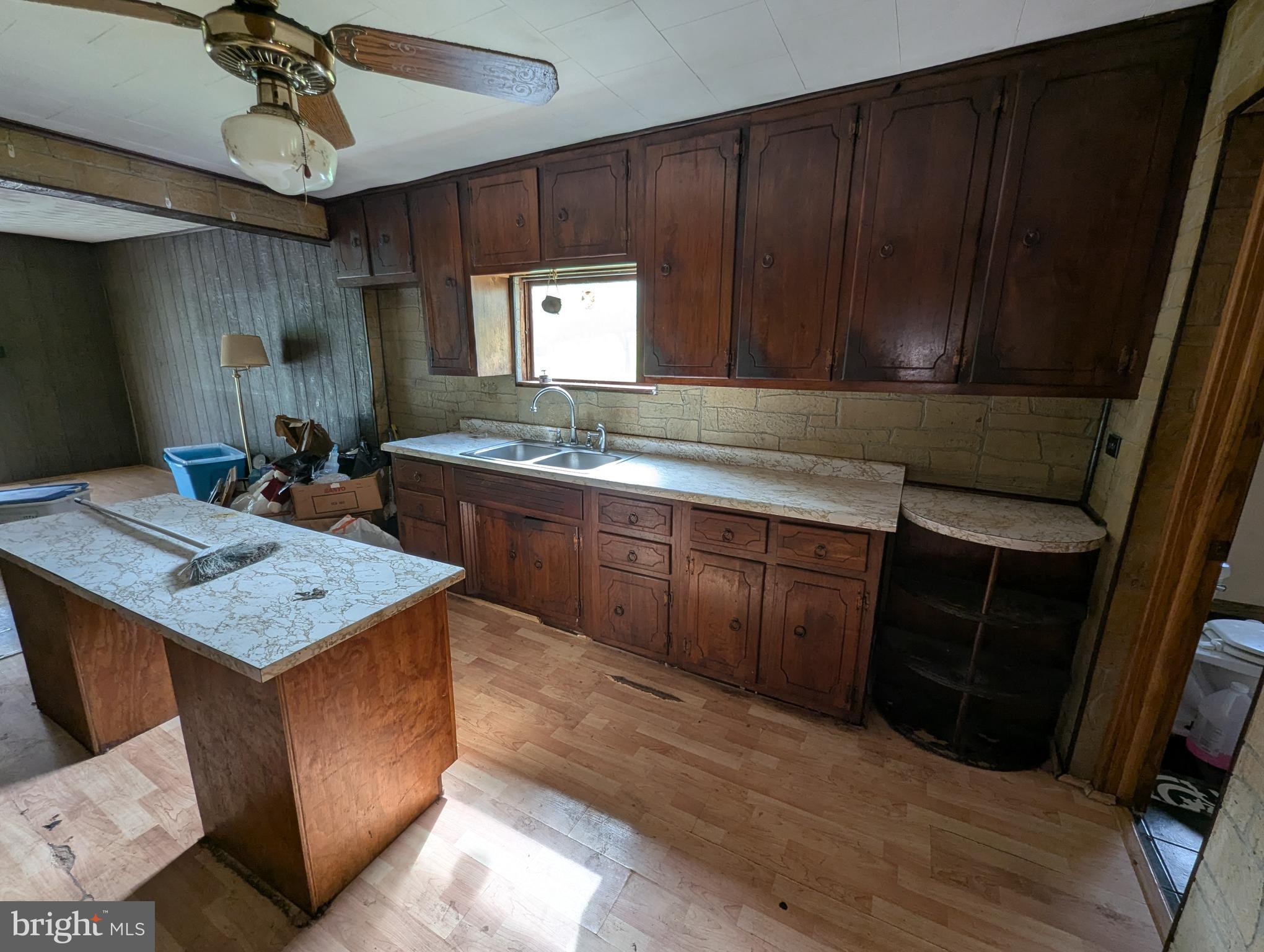 24001 Perry Hill Road Barton, MD 21521 - Photo 23 of 37 a kitchen with a sink cabinets and wooden floor