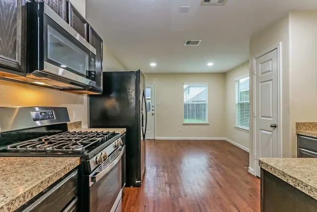 a kitchen with a stove and a microwave