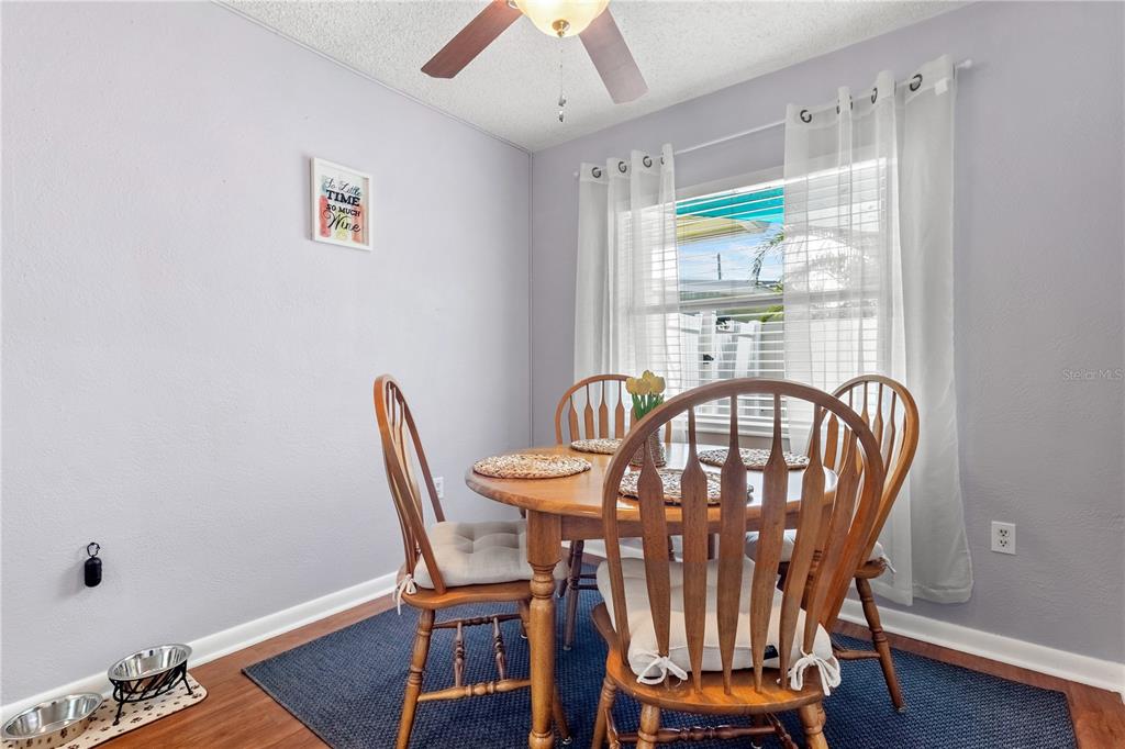 5596 100th Way North St. Petersburg, FL 33708 - Photo 17 of 67 a view of a dining room with furniture window and wooden floor