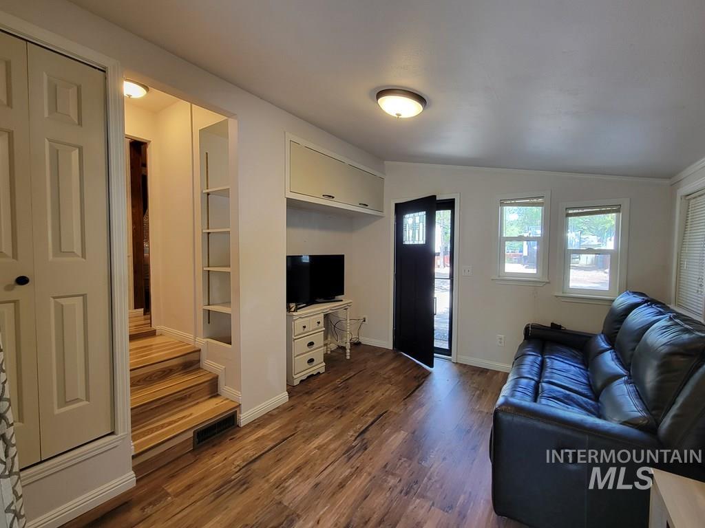 21 E Street Cascade, ID 83611 - Photo 9 of 26 Living area with lofted ceiling and dark wood-style flooring