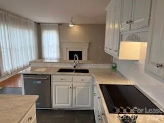 a kitchen with a sink stove and cabinets