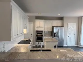 a kitchen with stainless steel appliances a refrigerator and a stove